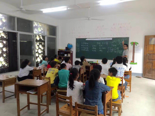 The main level of the building houses two classrooms and a community library. An outdoor playground and gathering area is located on the second level with access to the roof of the building accessible for the children to play and for villagers to rest.